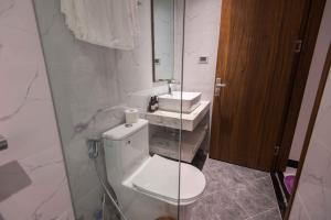a bathroom with a toilet and a sink at Paradise Boutique Hotel Hoàng Cầu in Hanoi