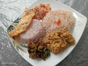 a plate of food with rice and other foods at Angel home villa in Dickwella