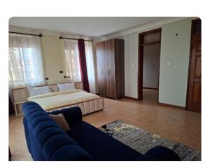 a living room with a bed and a couch at Elma Suites and Lounge in Kampala