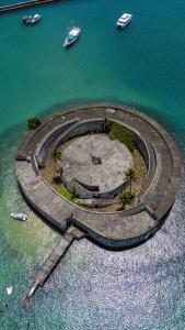 an island in the ocean with boats in the water at Loft Salvador in Salvador +3 photos