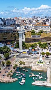 a city with boats docked in a harbor at Loft Salvador in Salvador
