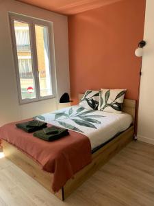 a bedroom with a large bed with a window at Le studio parisien in Clichy +7 photos