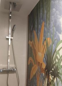 a painting on a wall with a shower curtain at Suite Zen Balnéo in Montpellier