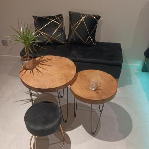 a living room with two tables and a couch at Suite Zen Balnéo in Montpellier