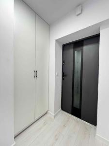 a room with white walls and a large glass door at Apartament Lubicz Dolny in Lubicz