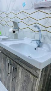 a white sink in a bathroom with a wall at Wadi Rum Abu Khaled in Wadi Rum +101 photos