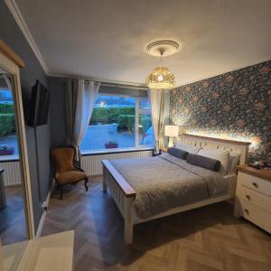 a bedroom with a large bed and a window at Salmon island view in Dromineer