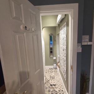 a door leading to a bathroom with a tile floor at Salmon island view in Dromineer +48 photos