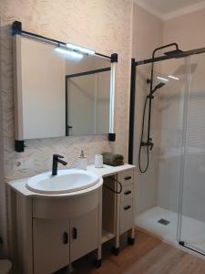 a bathroom with a sink and a shower at Apartamento Huelva Centro in Huelva +17 photos
