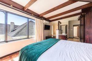 a bedroom with a large bed and a large window at Sun & Fun In Fresnaye - Family Summer in Cape Town +32 photos