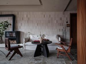 a living room with a couch and a table at See the mountains, find the place to stay in Xijiang