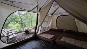 a tent with a view of a camp site at Pakis Camping Cikole in Tangkubanperahu