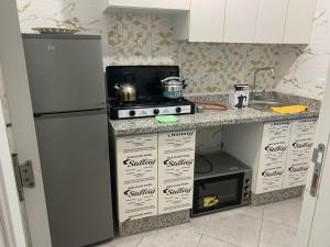 a kitchen with a refrigerator and boxes in it at HALA Chaouni in Tétouan