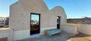 a building with a large window on top of it at Nile Domes Guest House in Luxor