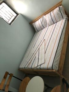 a loft bed in a room with a window at Blue Zone in Kigali