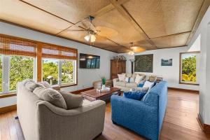 a living room with two couches and a table at A Tide that Binds Us By Beachside Management in Siesta Key