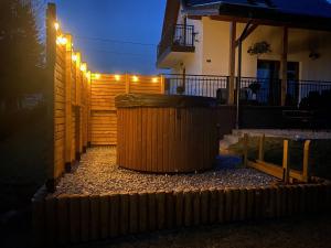 a fence with a trash can in front of a house at ORAWSKA CHATA - domek z balią pod Babią Górą in Zubrzyca Górna +72 photos