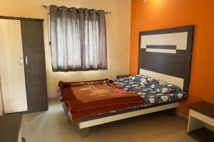 une chambre avec un lit dans une pièce dans l'établissement Hotel Sudama Palace - Mahabaleshwar , Couple & Family Stay Rooms with Free Wi-Fi & Delicious Food, à Mahabaleshwar