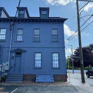 a blue house with a blue door on a street at Townhouse in Portsmouth Downtown Historic District in Portsmouth