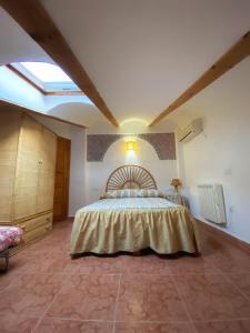 a bedroom with a bed in a room with a skylight at las 2 jotas in Guisando