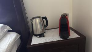 une table de chevet avec une cafetière et un mixeur dessus dans l'établissement Hotel Mina, à Craiova