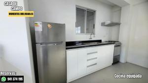 a small kitchen with a stainless steel refrigerator at Escápate con tu pareja sin salir de Lima in Cieneguilla