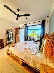 a bedroom with a bed with a view of the ocean at Marea Boutique Hotel in Jambiani
