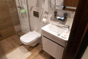 a bathroom with a toilet and a sink and a shower at Pause parfaite in El Aouina Station +5 photos