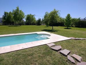 a swimming pool in the middle of a grass field at Cabaña El Morito in San Rafael