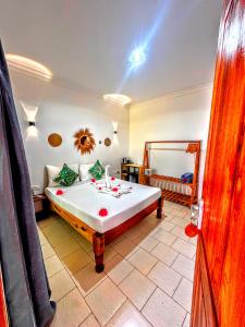 a bedroom with a large bed in a room at Marea Boutique Hotel in Jambiani