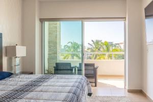 ein Schlafzimmer mit Bett und Blick auf das Meer in der Unterkunft Golf Course View Apartment in Mazatlan in Los Cerritos
