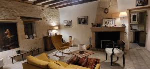 a living room with a couch and a fireplace at Maison au cœur des châteaux. in La Chapelle-aux-Naux +25 photos