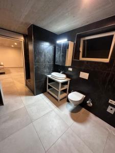 a bathroom with a toilet and a sink at Innsbruck West in Inzing