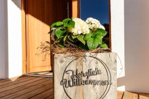 a wooden vase with a bouquet of flowers in it at am Egg in Rettenberg +11 photos