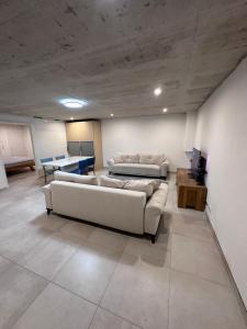 a living room with two couches and a table at Innsbruck West in Inzing