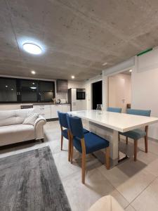 a kitchen and living room with a table and chairs at Innsbruck West in Inzing +16 photos