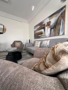 a living room with a couch and a table at Modern Central Studio - Dakar Plateau in Dakar