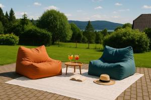 two chairs sitting on a blanket with a table and glasses at Villa Slupečná in Lipno nad Vltavou