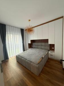 a bedroom with a large bed and a chandelier at Villa Marina in Novoberdo +14 photos