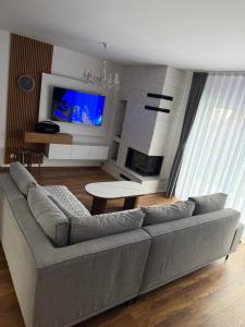 a living room with a couch and a tv at Villa Marina in Novoberdo
