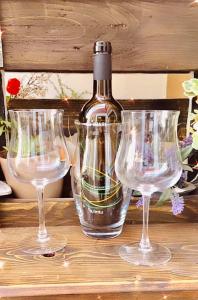 three empty wine glasses sitting on a wooden shelf at Living G Room in Cagliari +26 photos