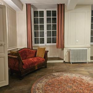 a living room with a couch and a window at Gite Maison Loyac in Tulle