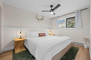 1 dormitorio blanco con 1 cama grande y 2 lámparas en 249 E Coyote, en Silverthorne 53 fotos más