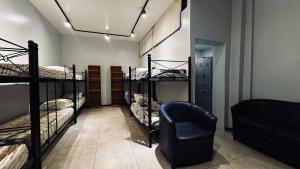 a room with four bunk beds and a chair at Sumaq Hostel Backpackers in Buenos Aires +29 photos