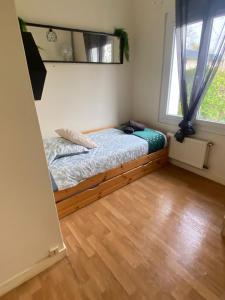 a bedroom with a bed in a room with a window at Gîte Au Gré du Canal ZOO Beauval 4 personnes parking in Selles-sur-Cher +18 photos