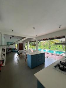 a kitchen and living room with a view of a pool at Forest Avenue - Kurunegala in Torayaya