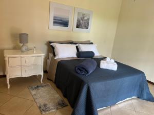 a bedroom with a bed with a blue blanket and a night stand at Sítio Céu da Mantiqueira in Espirito Santo Do Pinhal +38 photos