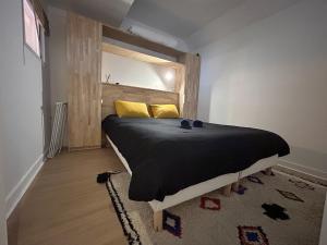 Schlafzimmer mit einem Bett und einem Spiegel an der Wand in der Unterkunft T2 au cœur de Niort, proche marché & Port Boinot in Niort