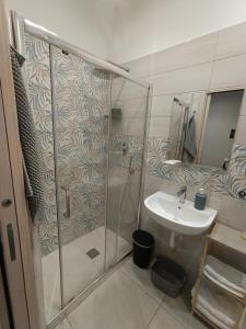 a bathroom with a shower and a sink at La casa di Flò in Ercolano +7 photos