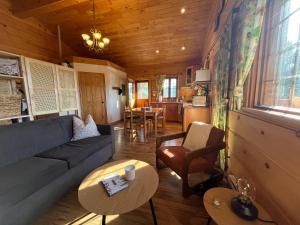 a living room with a couch and a table at Radium Cabins Centrally located in Radium Hot Springs BC in Radium Hot Springs